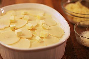 homemade scalloped potatoes in dish ready to bake