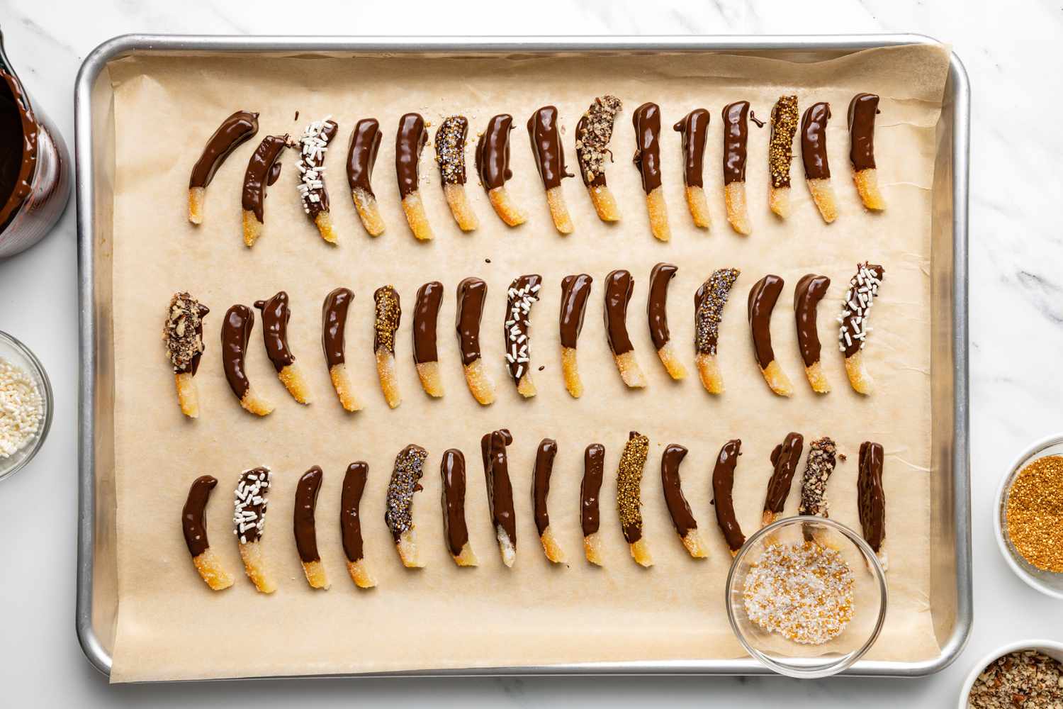 Recently Dipped and Decorated Chocolate Covered Orange Peels Drying on a Baking Sheet 