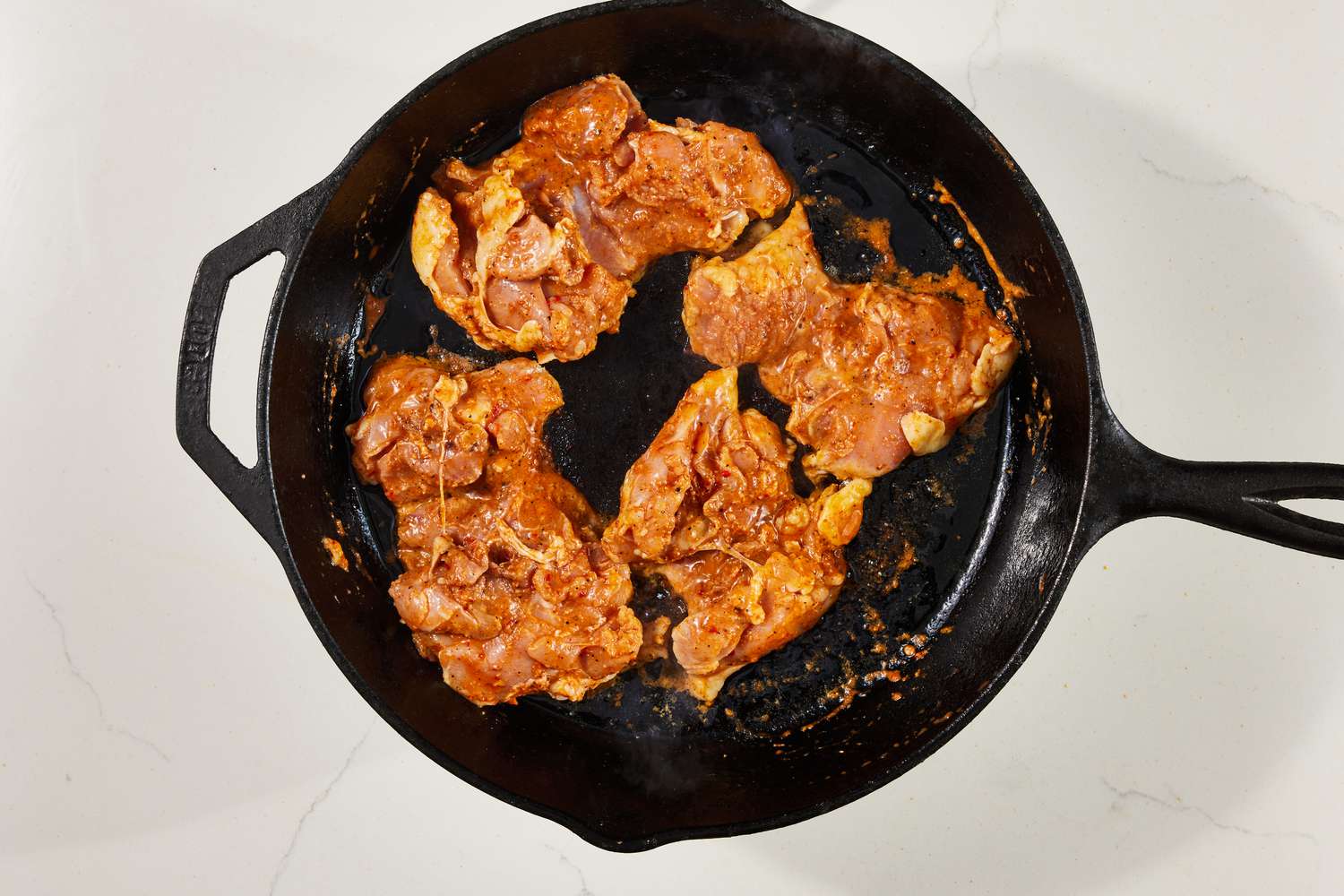 Copycat Chipotle chicken cooking on a cast iron skillet