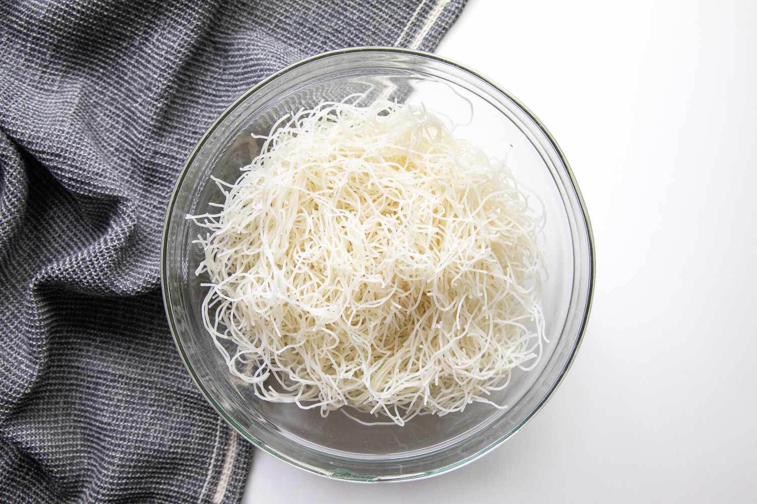 Pancit Bihon Noodles in a Bowl Sprinkled with a Little Bit of Water for Filipino Rice Noodles with Pork Recipe