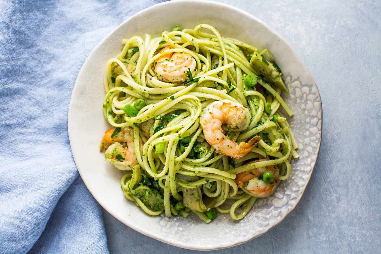 A plate of artichoke and shrimp pasta ready to eat