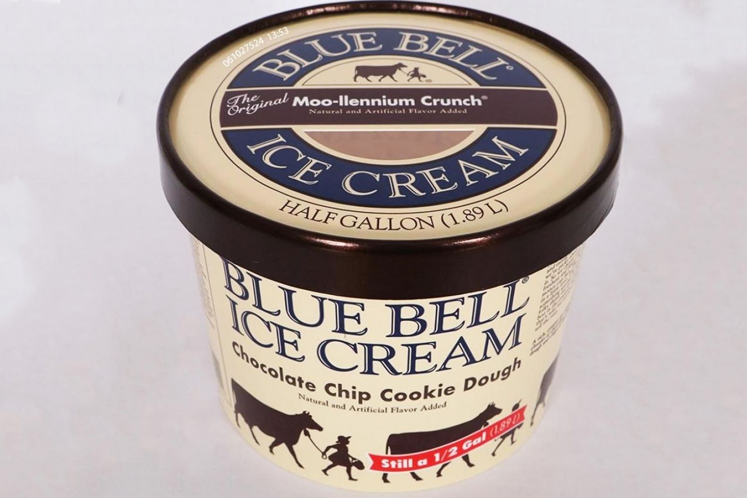 A container of Blue Bell chocolate chip cookie dough ice cream on a white background