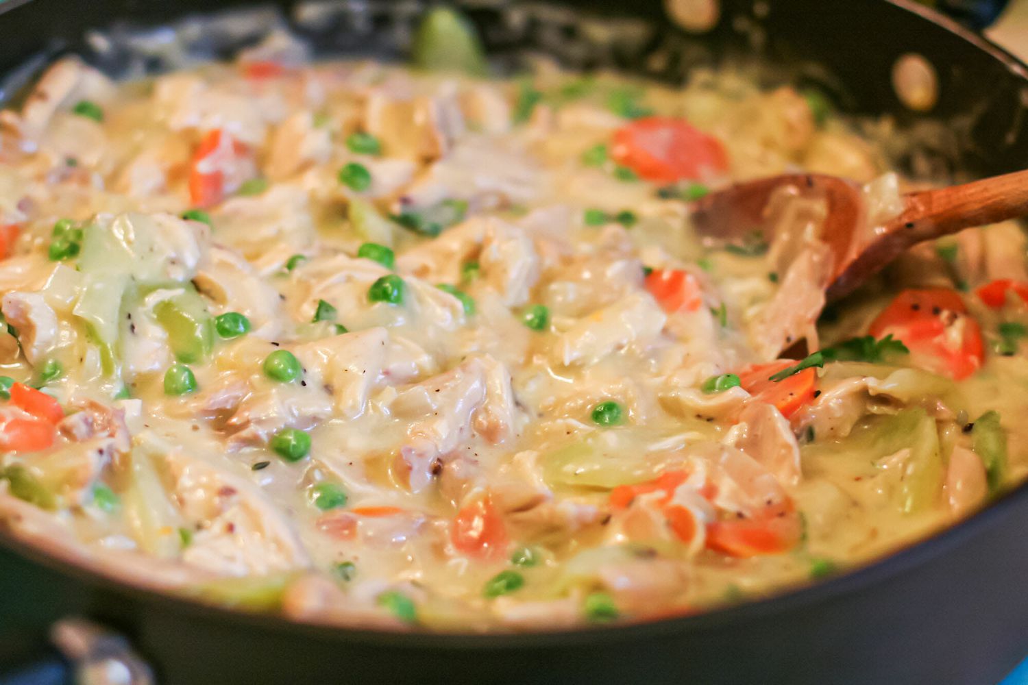 Homemade chicken pot pie filling cooking in a skillet.