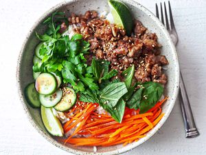 how to make Pork Rice Bowl Recipe herbs in center of bowl with pork and carrots on side
