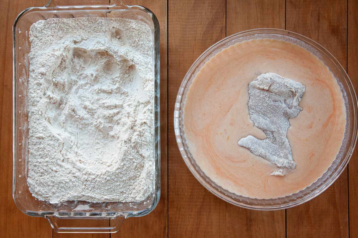 Floured chicken thigh set in the wet mixture for a Nashville-style hot fried chicken.