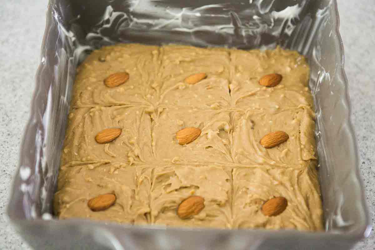 cut pattern into uncooked batter for almond blondies