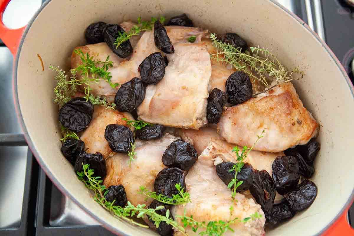 add prunes and thyme to rabbit in dutch oven