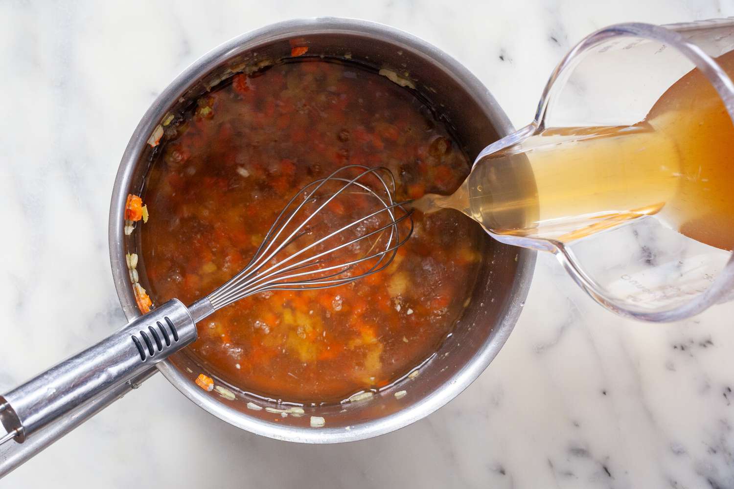 Add broth to onions, celery, and carrots for classic espagnole sauce