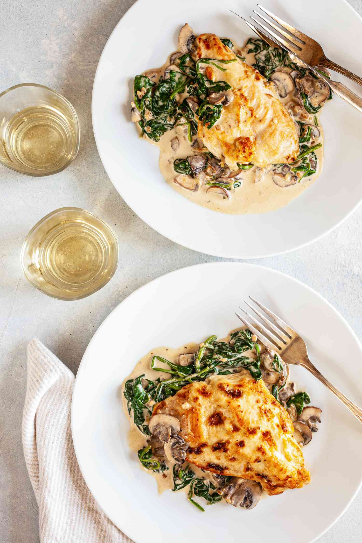 Two plates of chicken Florentine.