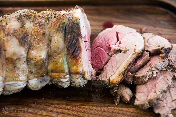 Thick slices of roasted leg of lamb with perfectly pink center