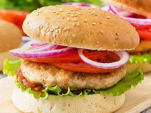 Turkey burger with lettuce, tomato, onion on a sesame seed bun