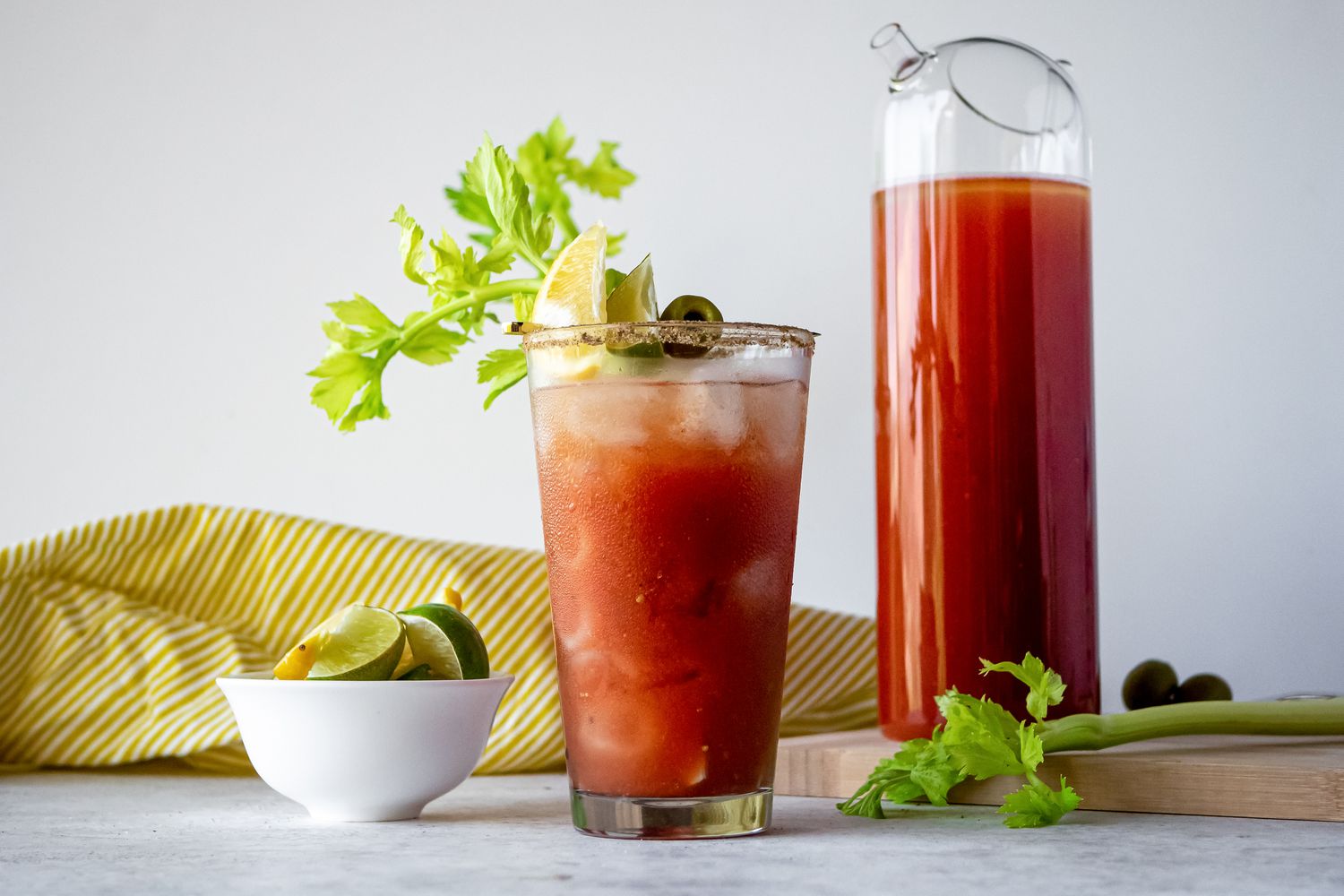 Traditional bloody Mary mix served in glass and held in pitcher.