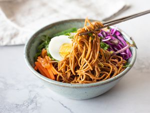 Bibim Guksu (Korean Spicy Cold Noodles) Picked up with Chopped Sticks