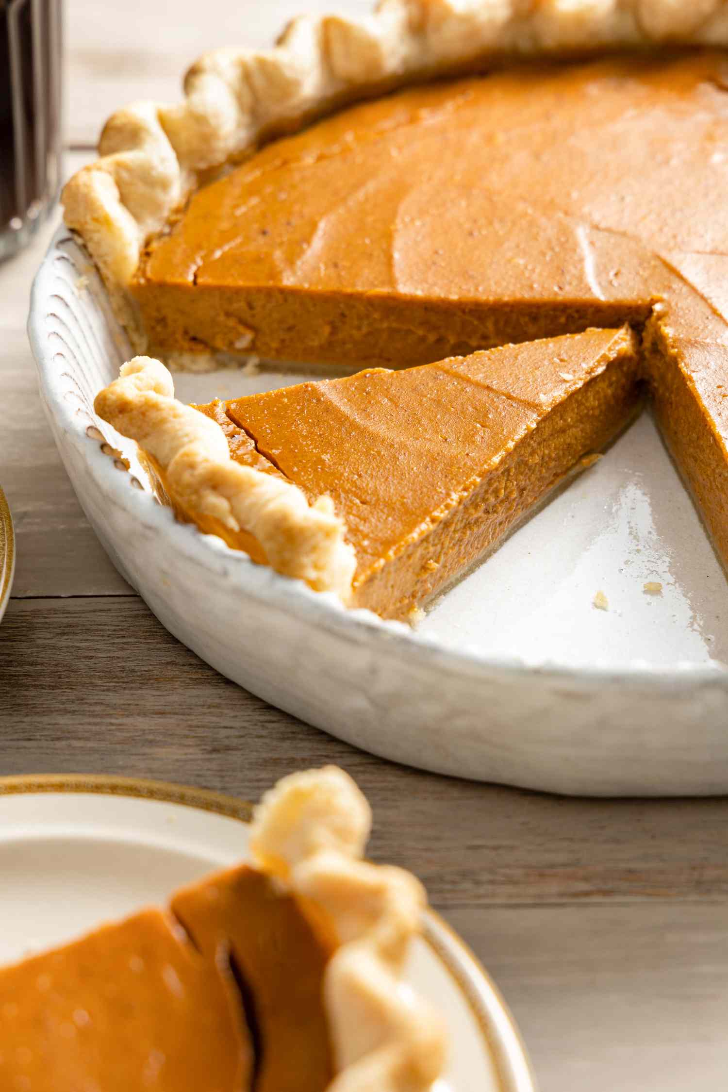 Vegan Pumpkin Pie in a Pie Dish with a Slice of Pie Cut Out