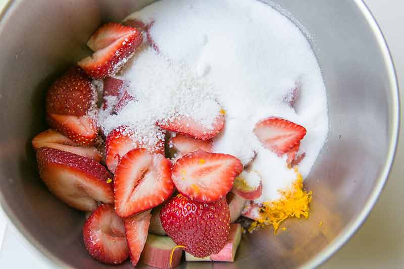 toss strawberries and rhubarb with sugar, orange zest, and instant tapioca to make the filling for the strawberry rhubarb pie