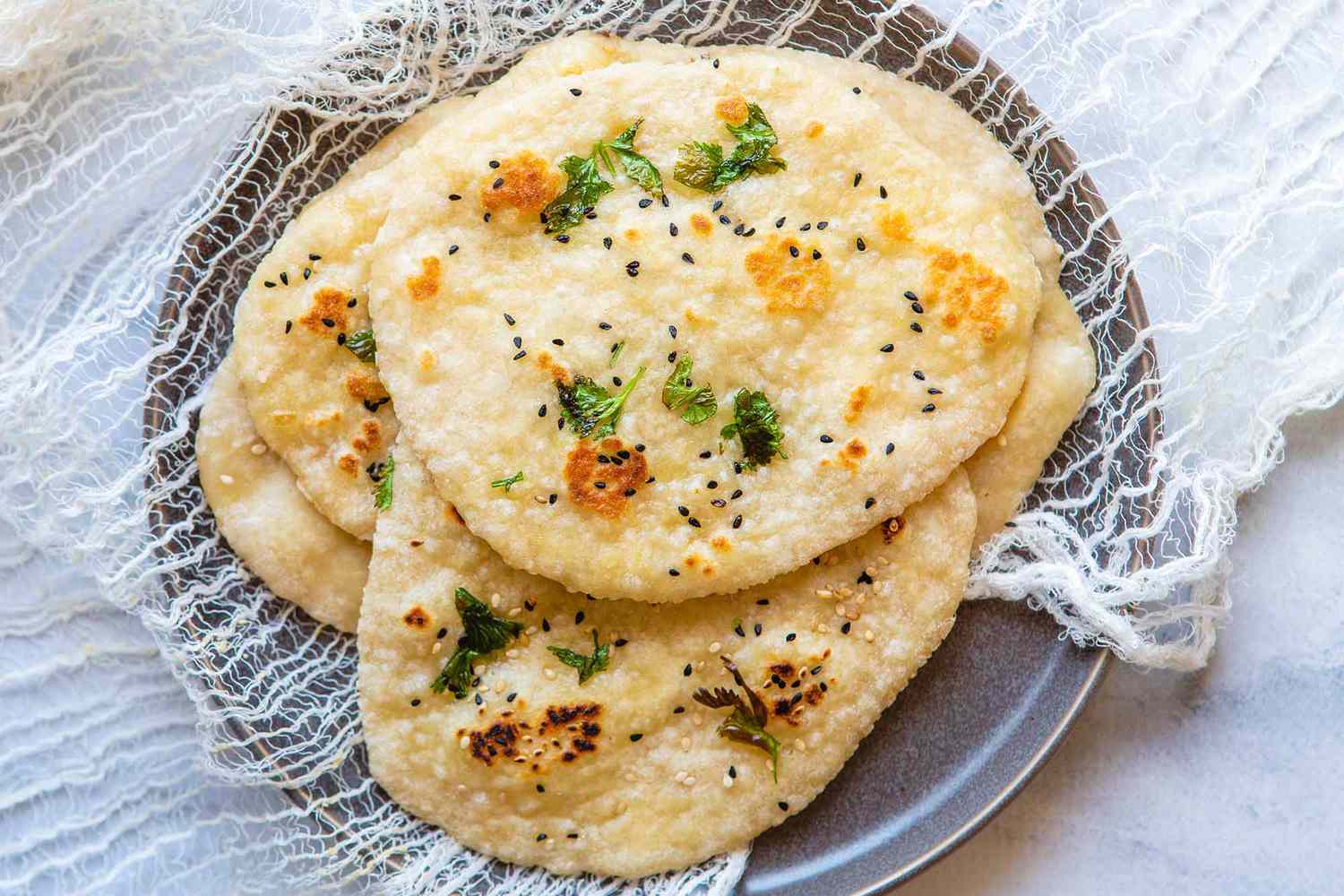 Naan Recipe - Naan with herbs on grey plate