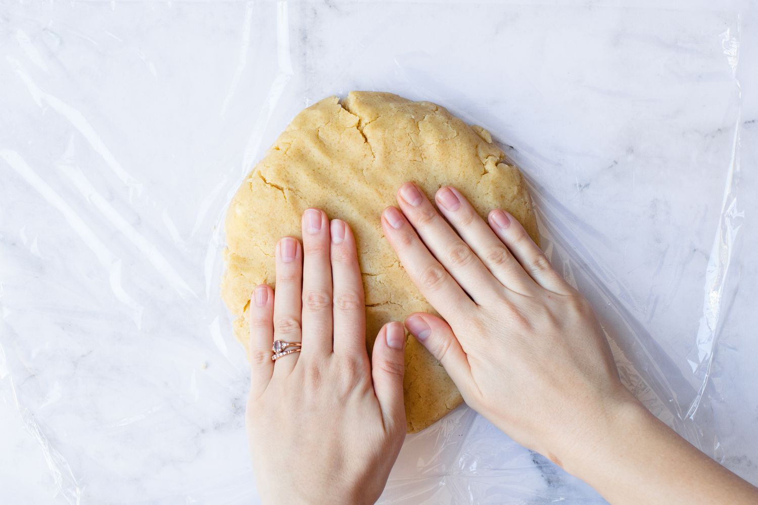 Wrapping almond cookie dough in plastic wrap.