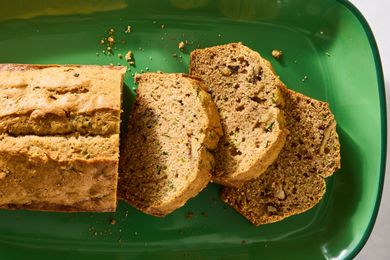Sliced zucchini bread on a green serving tray