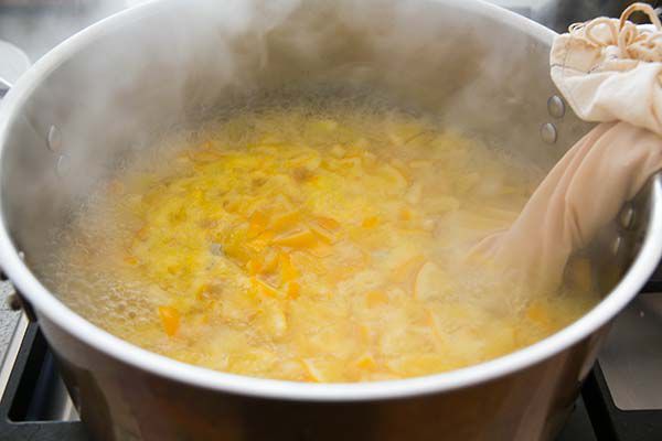 Chopped Meyer lemons simmering in a pot to make marmalade
