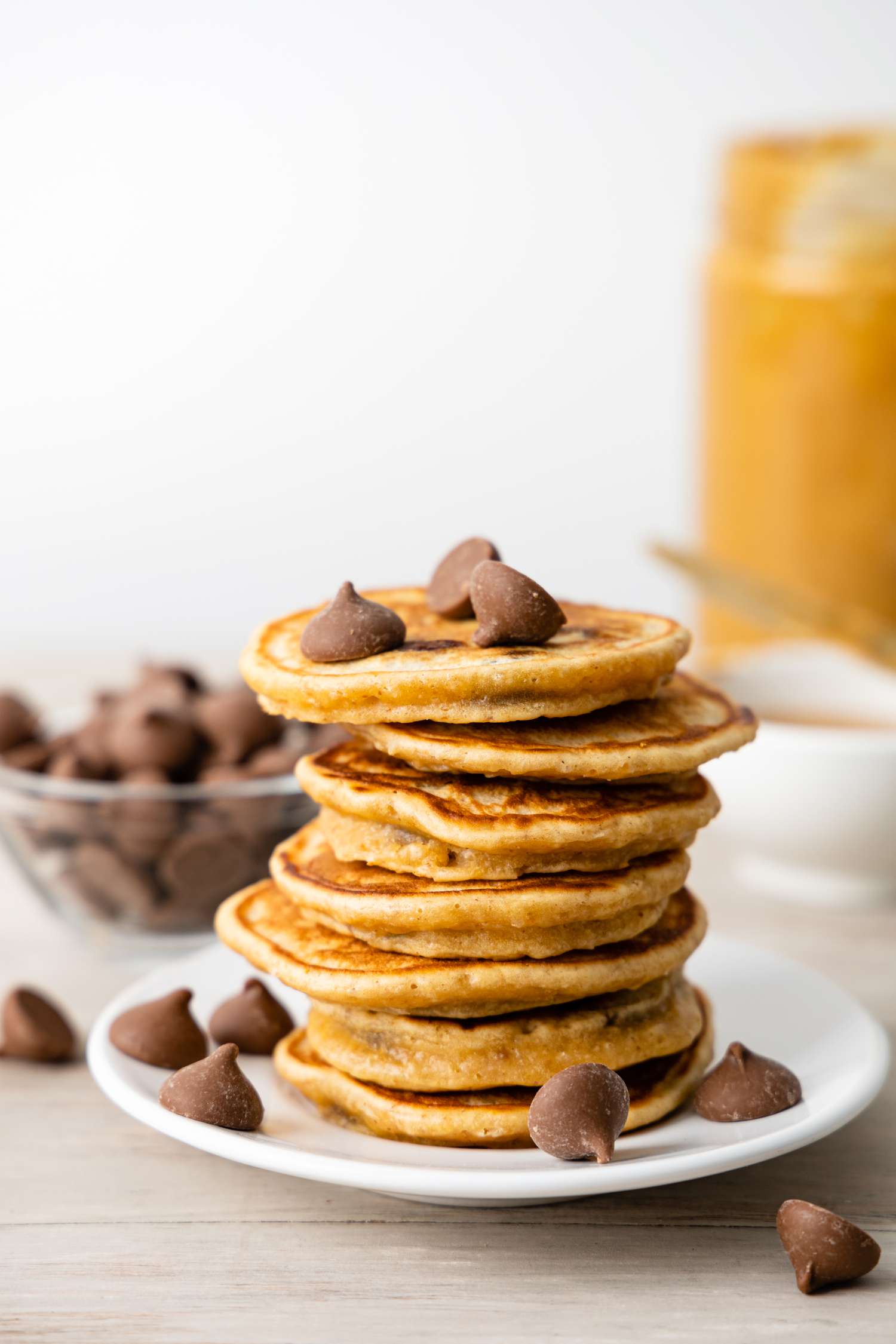 Stack of Buckeye Pancakes on a Plate Surrounded by Chocolate Chips