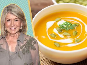 Martha Stewart next to a bowl of butternut squash soup topped with garnishes