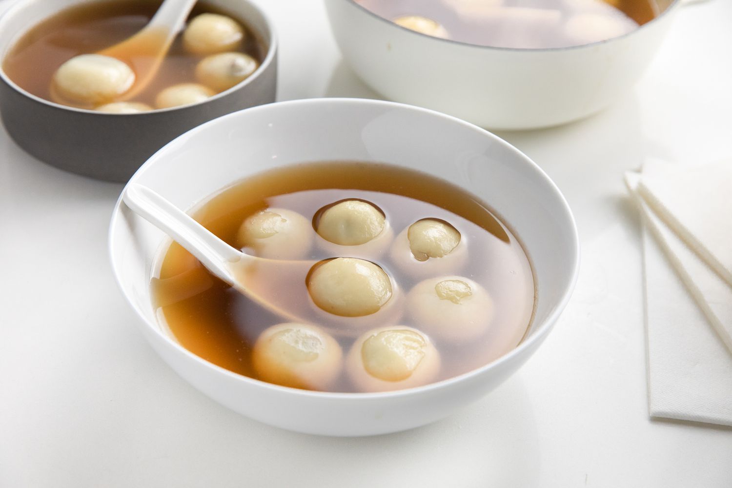Bowl of Red Bean Tangyuan, and in the Background, a Pot and a Bowl with More