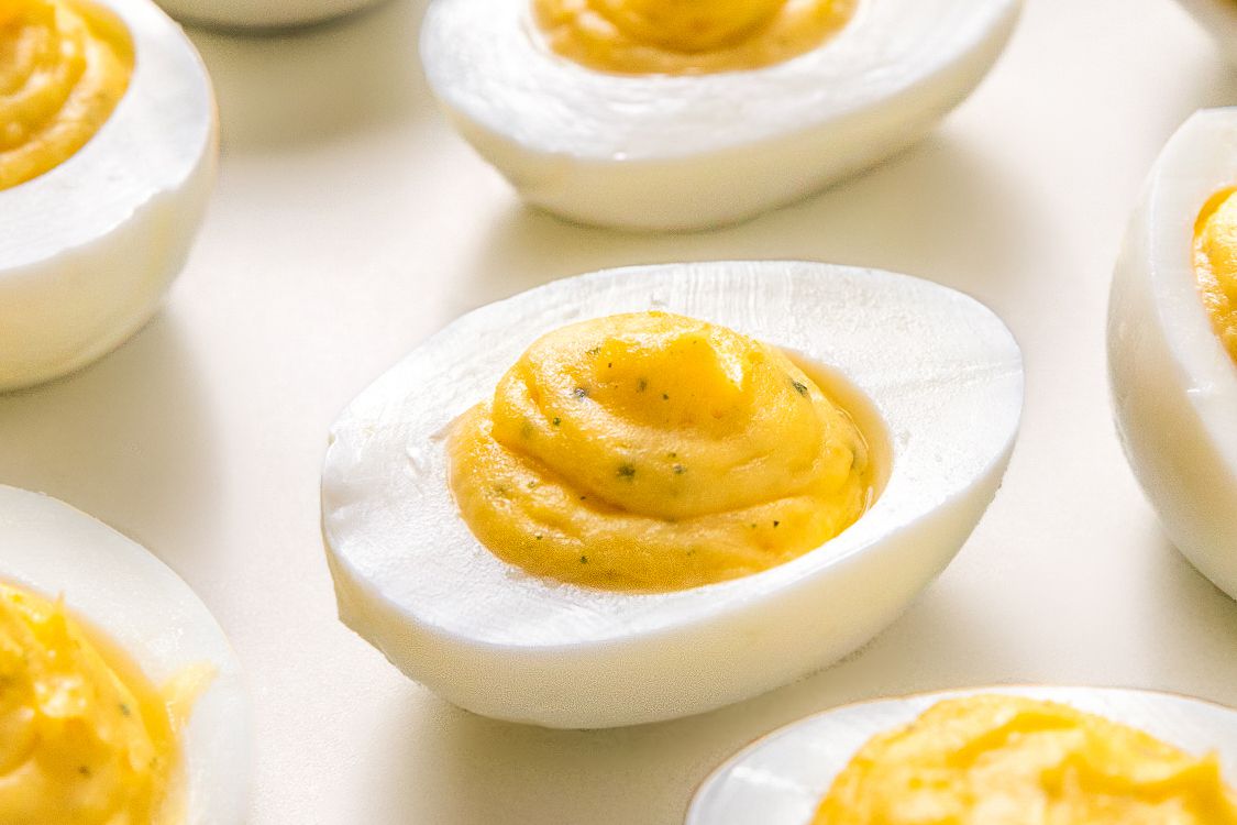 Deviled eggs with a creamy filling displayed on a surface