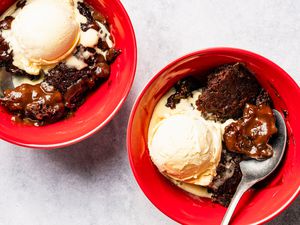 Samantha Seneviratne's 10-Minute Microwave Chocolate Pudding Cake in bowls with a scoop of ice cream and spoons