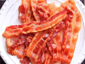 Cooked bacon strips arranged on a plate