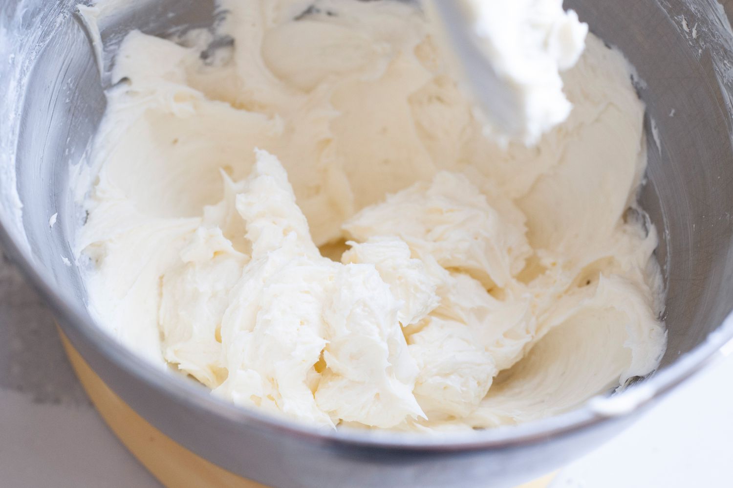 Beat cream cheese for key lime cheesecake.