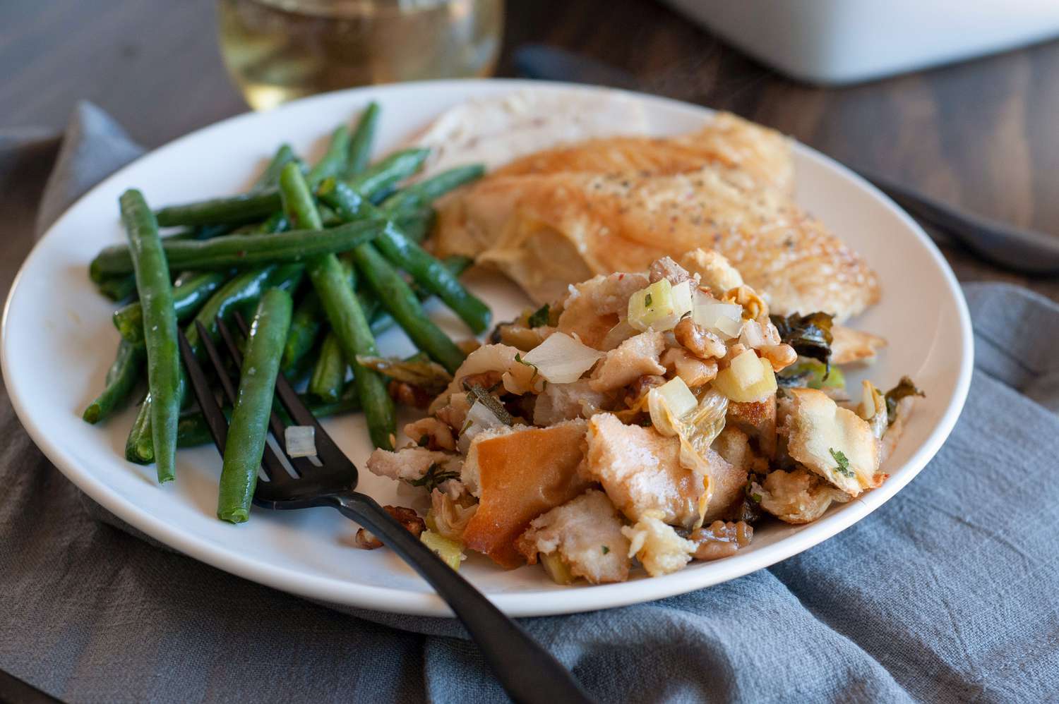 Kimchi stuffing on a plate with green beans.