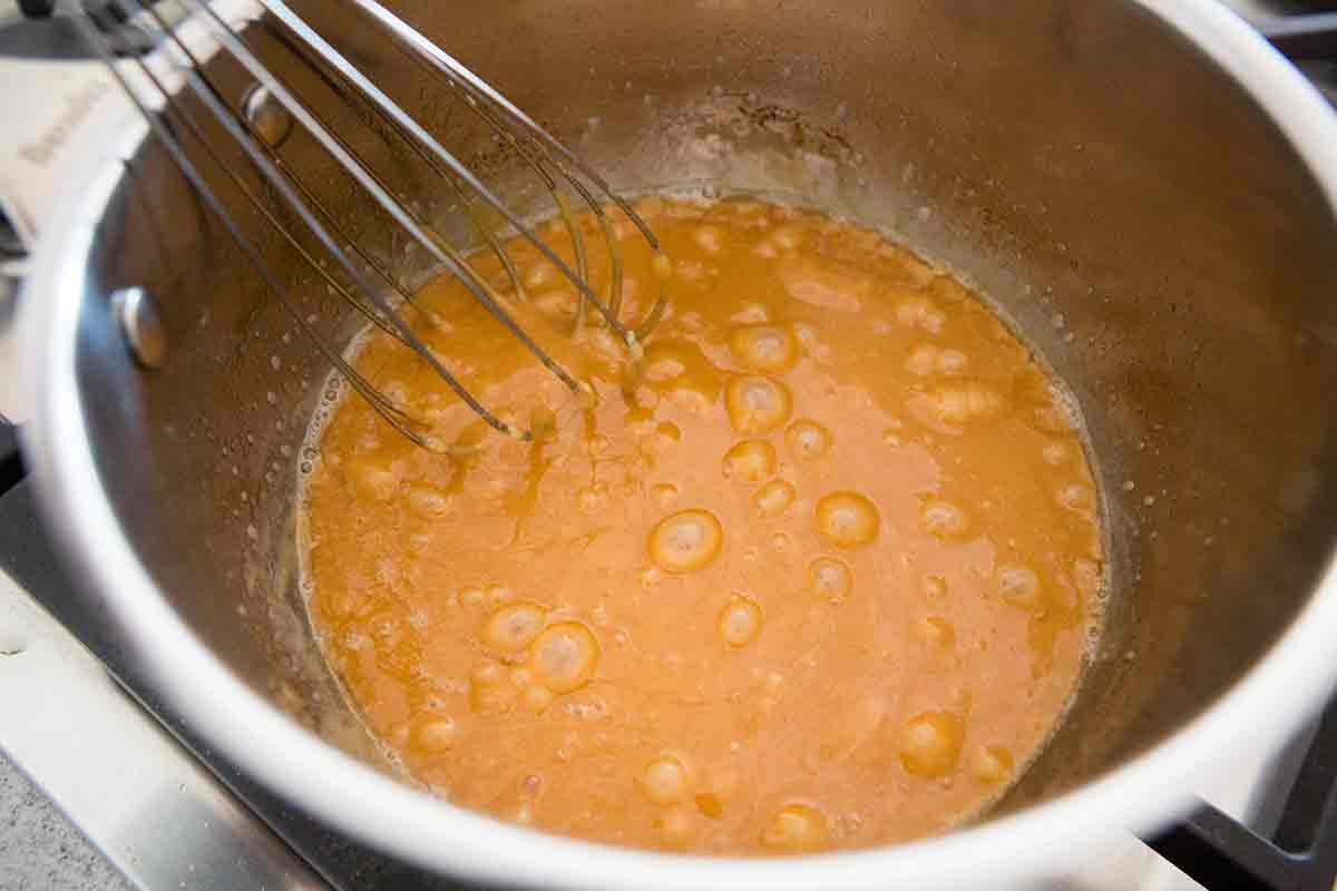 whisking caramel sauce until smooth
