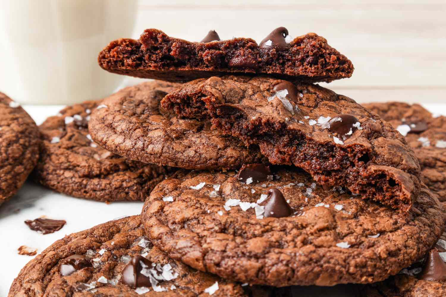 a 3-ingredient brownie cookie cut in half and sitting on a pile of more cookies