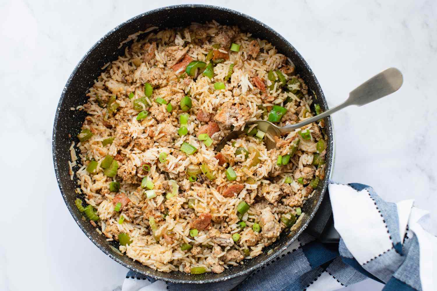 Overhead view of dirty rice in a skillet.