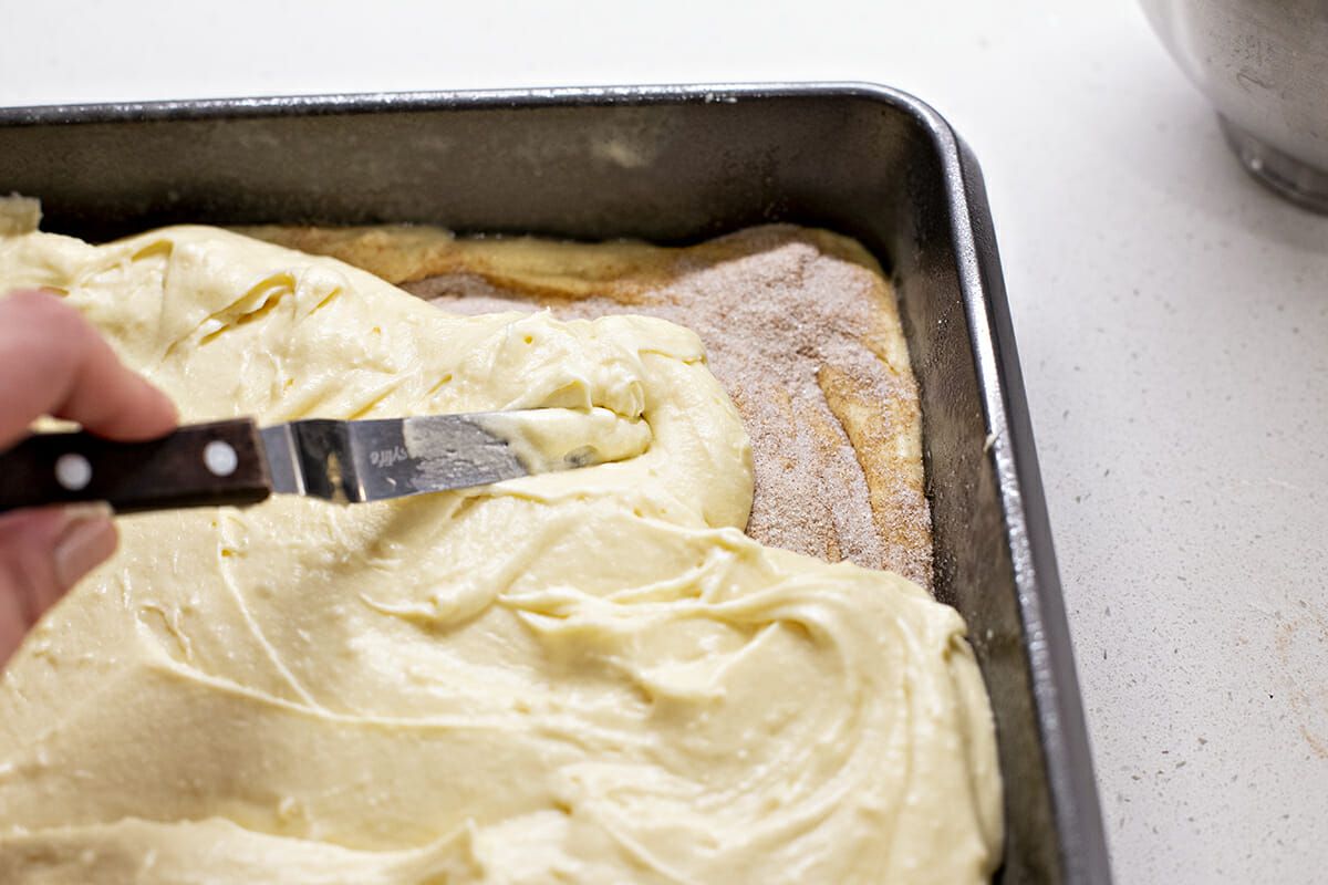 Cake batter in pan being topped with an extra layer of batter