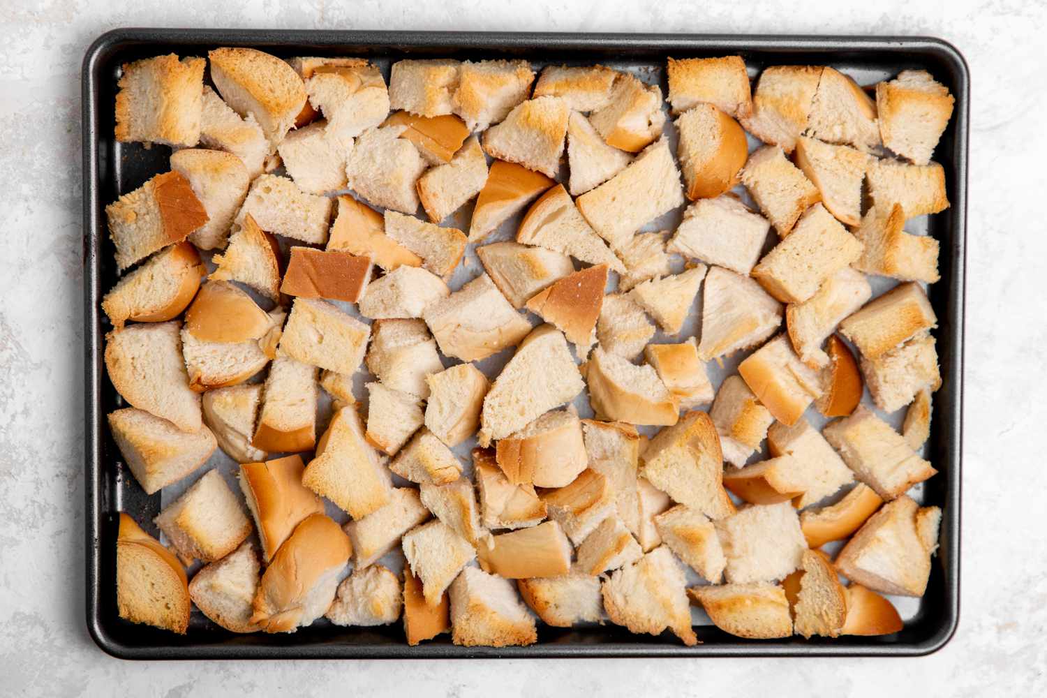 Cubes of Bread on Sheet Pan for Apple Bread Pudding Recipe