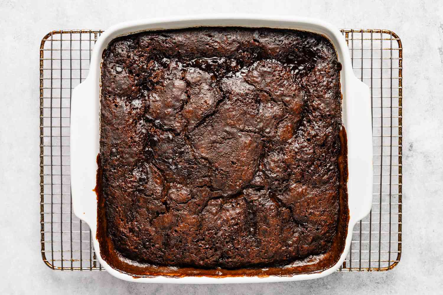 chocolate pudding cake cooling on a metal rack