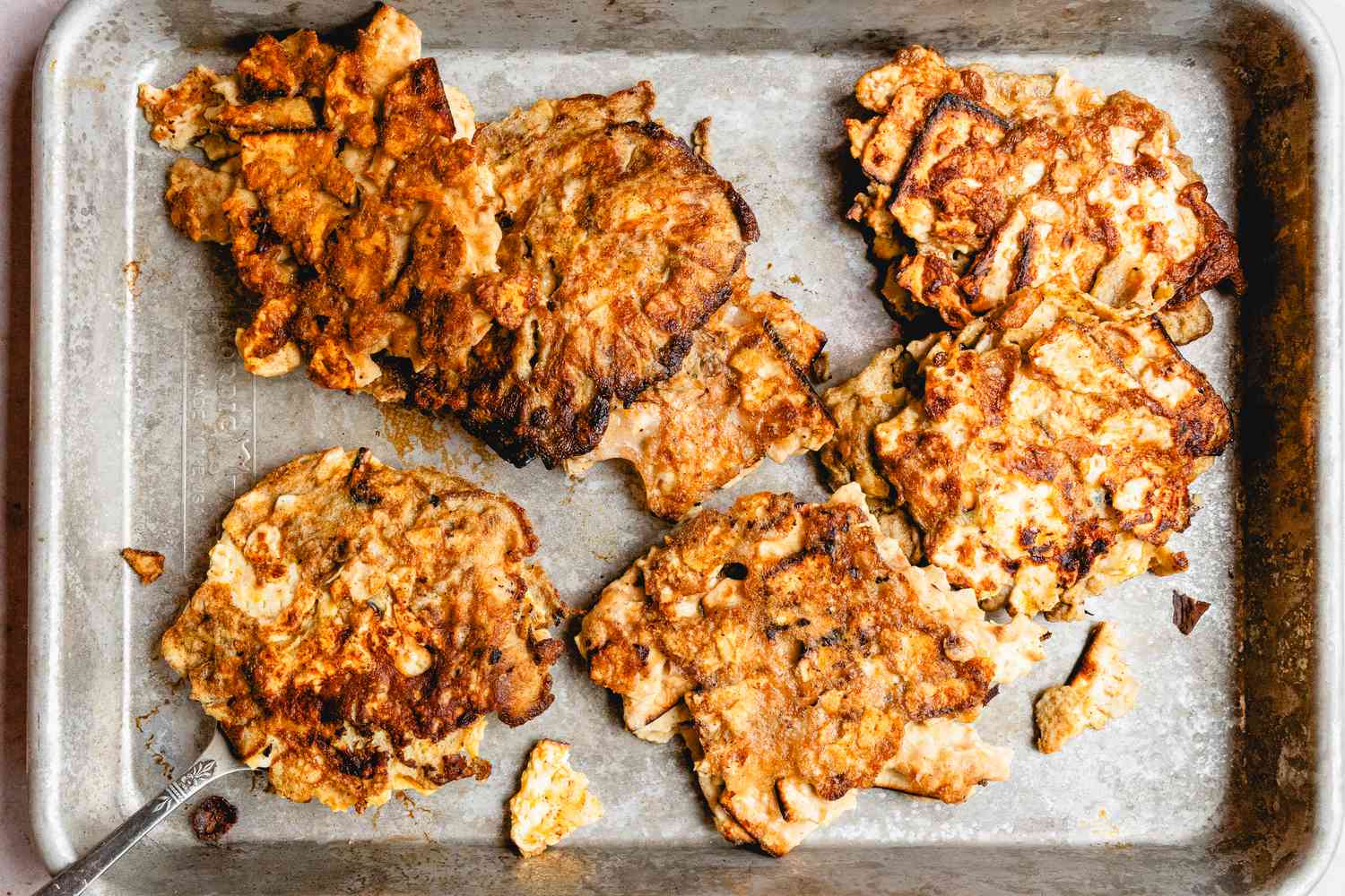 Overhead view of a metal warming pan of Matzo Brei Pancakes
