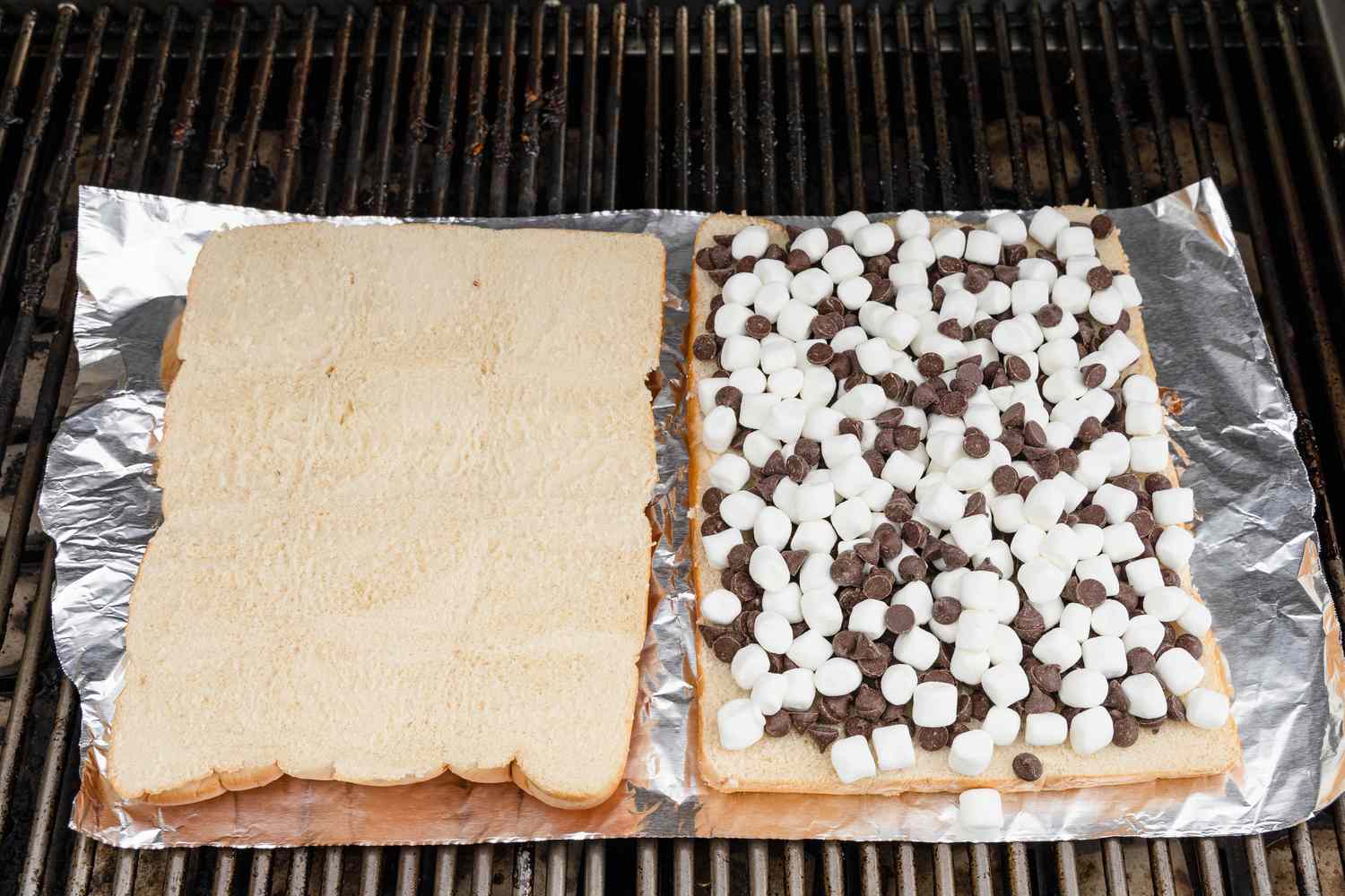 Aluminum Foil With Both Halves of Slider Loaf (One Half Is Empty and the Other Has the Toppings) on the Grill