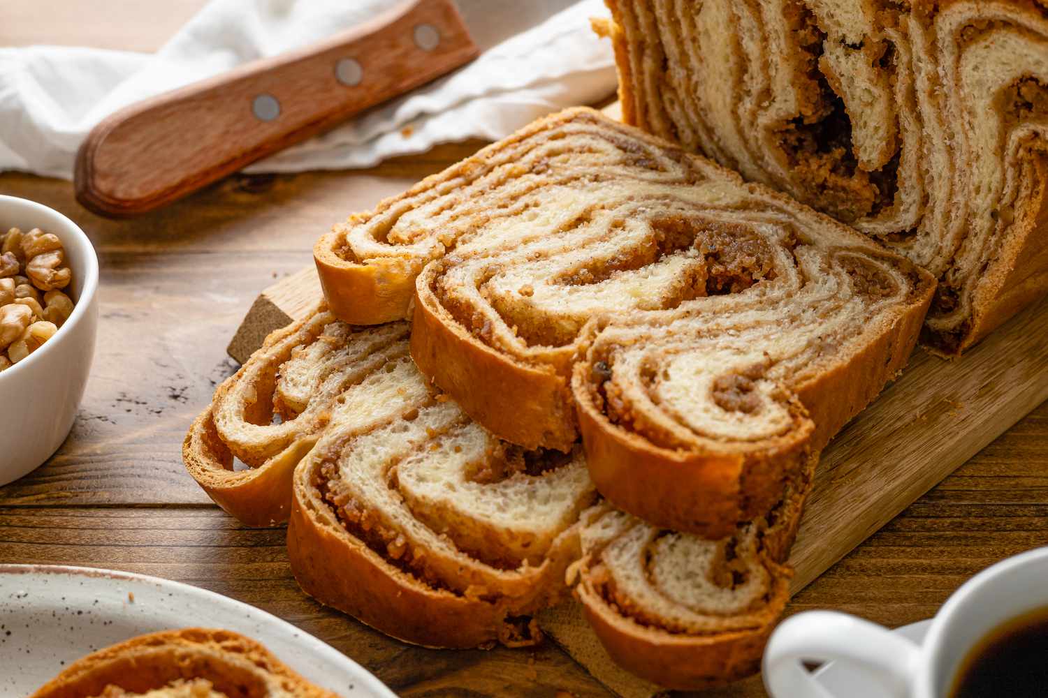 Slices of Povitica Next to the Loaf on a Cutting Board