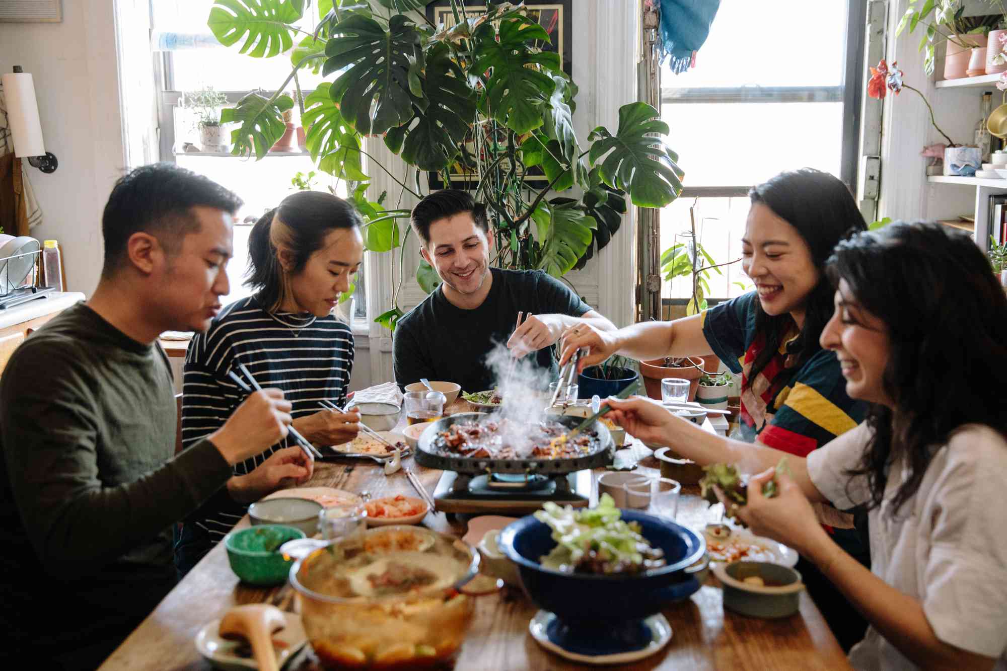 A group of friends around a table enjoying Korean BBQ