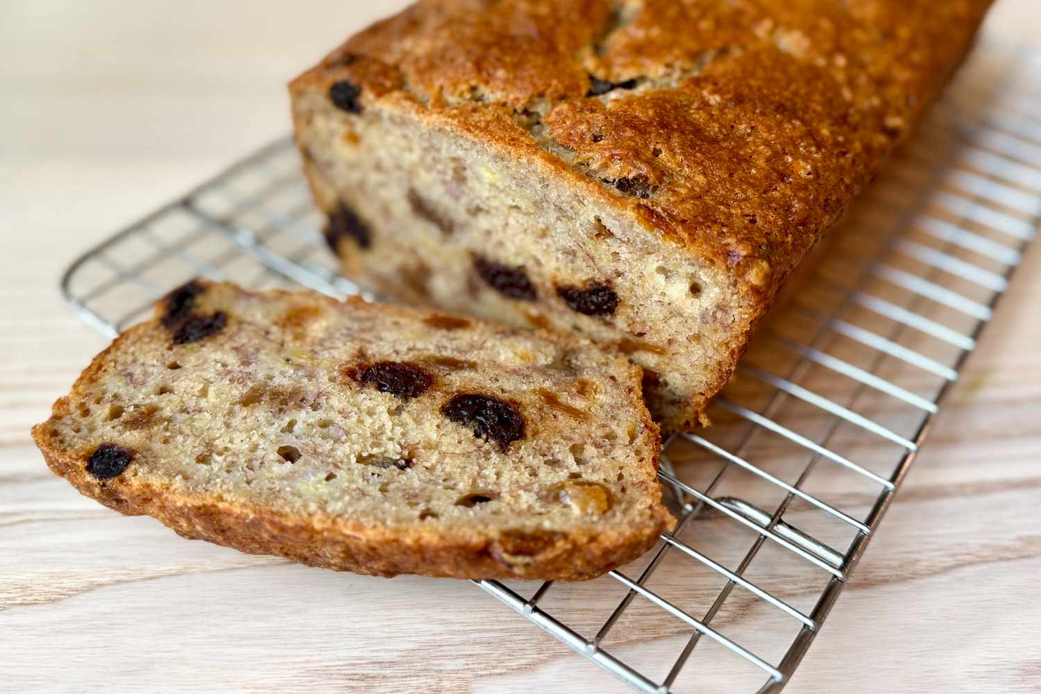 Side shot of a banana bread with a slice cut off