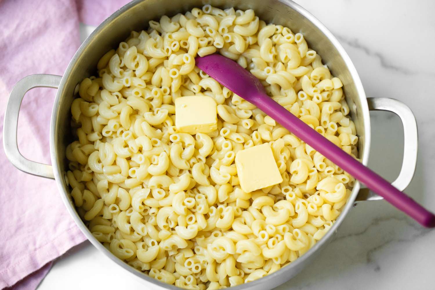 Butter Added to Macaroni in a Pot for Macaroni Pie Recipe