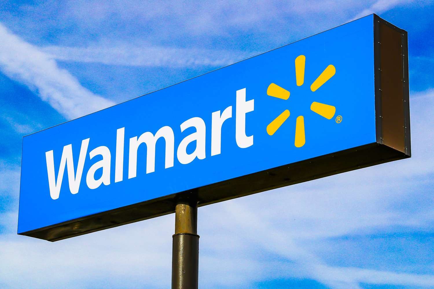 A Walmart sign against a blue sky