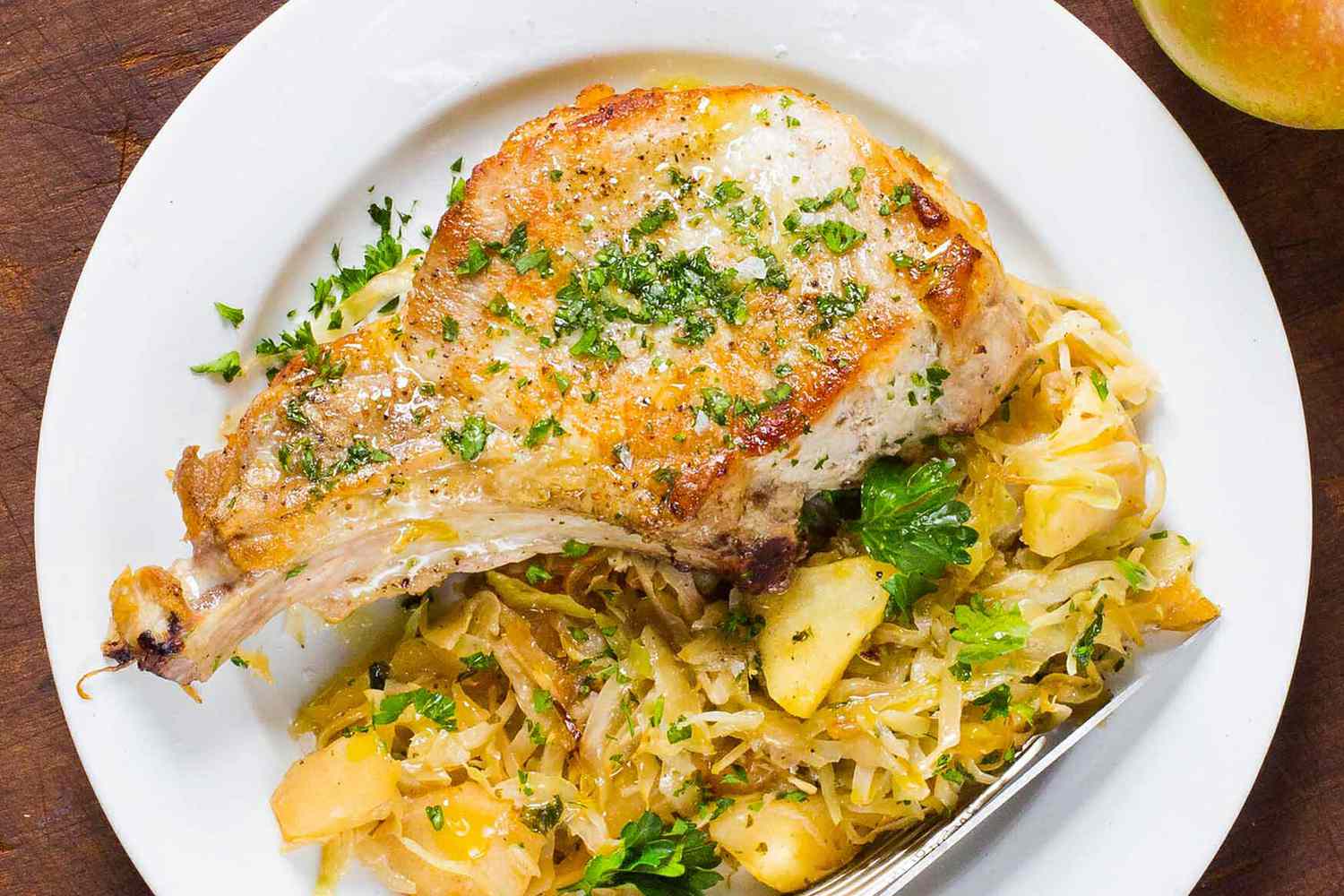 A plate of pork chop with cabbage