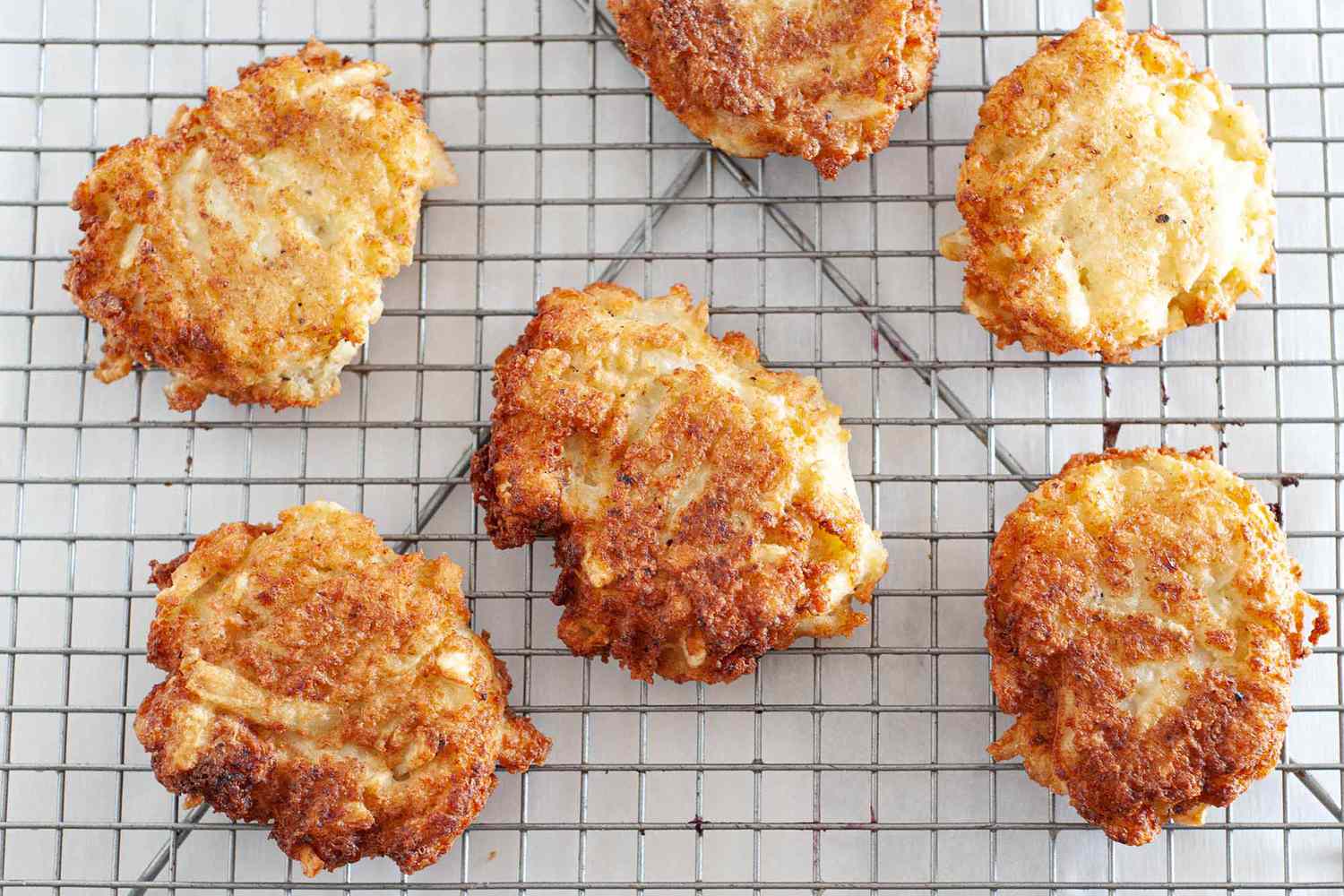 Fried potato latkes on a cooling rack