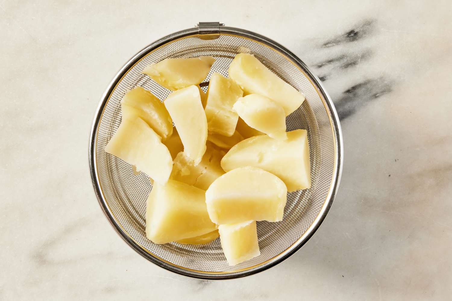 cooked potatoes in a colander for Korean-style potato salad recipe