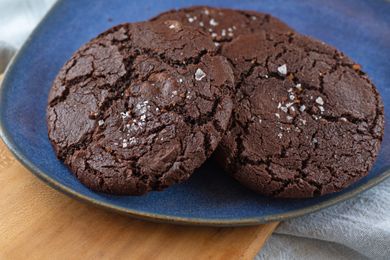 Chocolate cookies with a sprinkle of salt on a blue plate