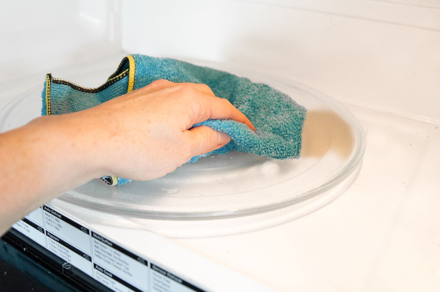 Microwave Interior Wiped with a Microfiber Towel for How to Clean a Microwave