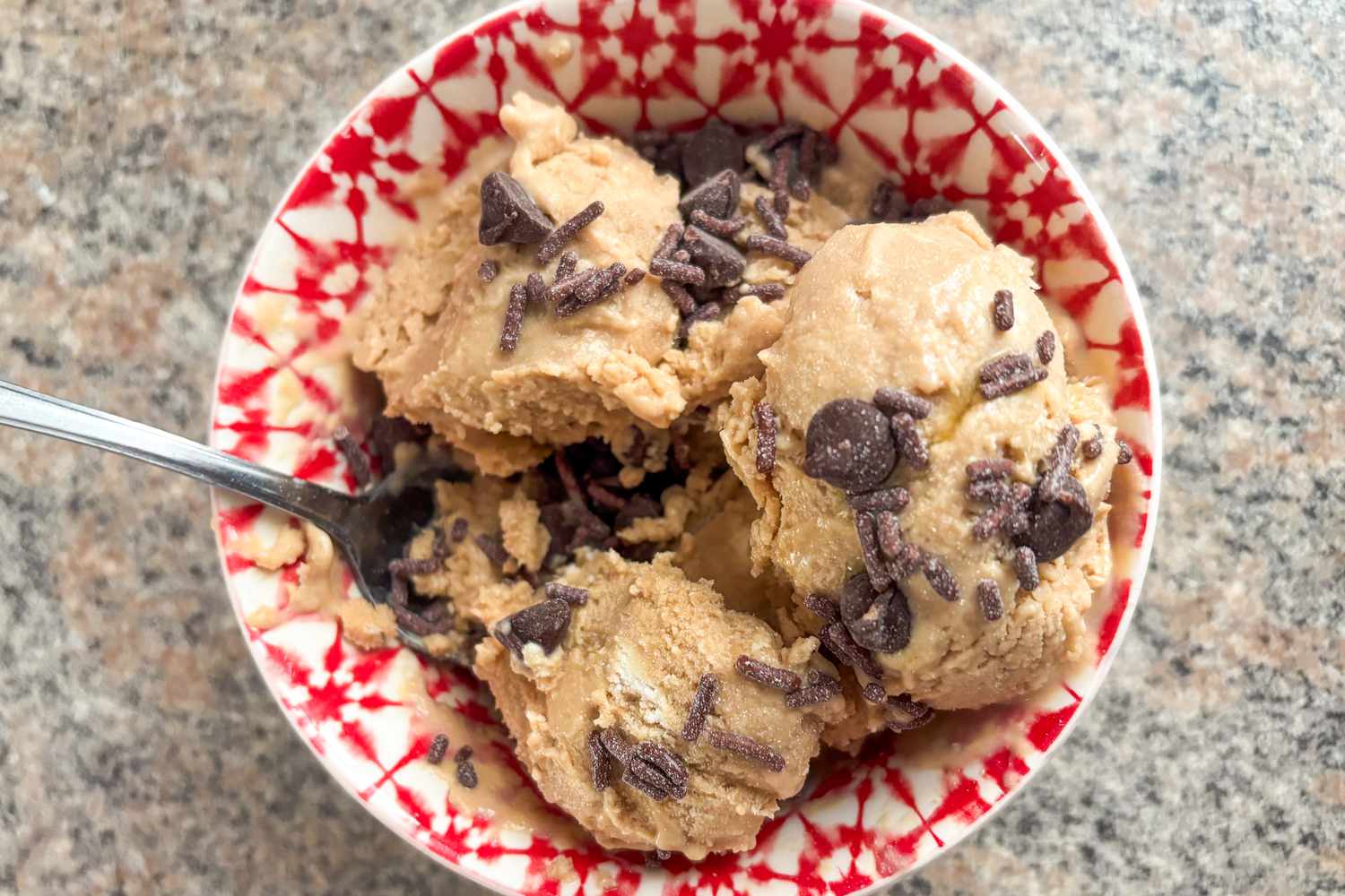 A bowl of ice cream topped with chocolate shavings